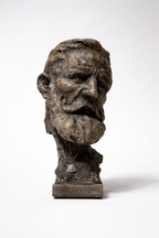 Aged bronze-toned sculpture of Mimir, an old man's head with a rugged, textured finish and deep wrinkles, on a white background.