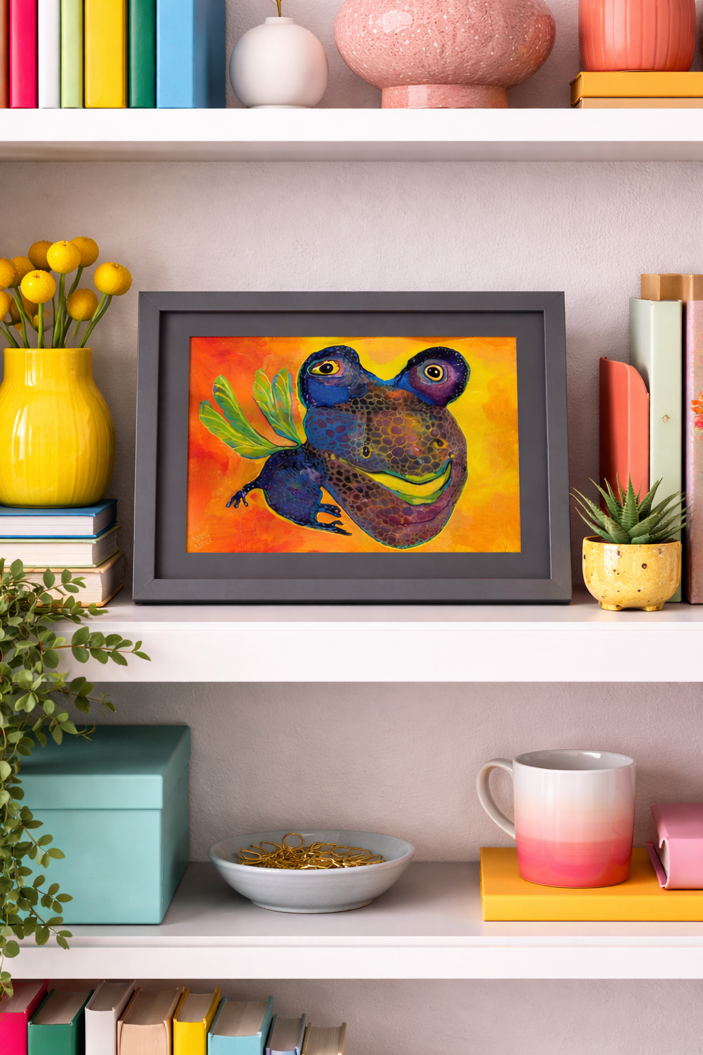 Colorful art painting of two winged, frog-like creatures in blue and purple against an orange and yellow background, framed in dark gray.