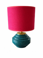 Cherry pink fabric table lamp with a teal ribbed base and gold accent.