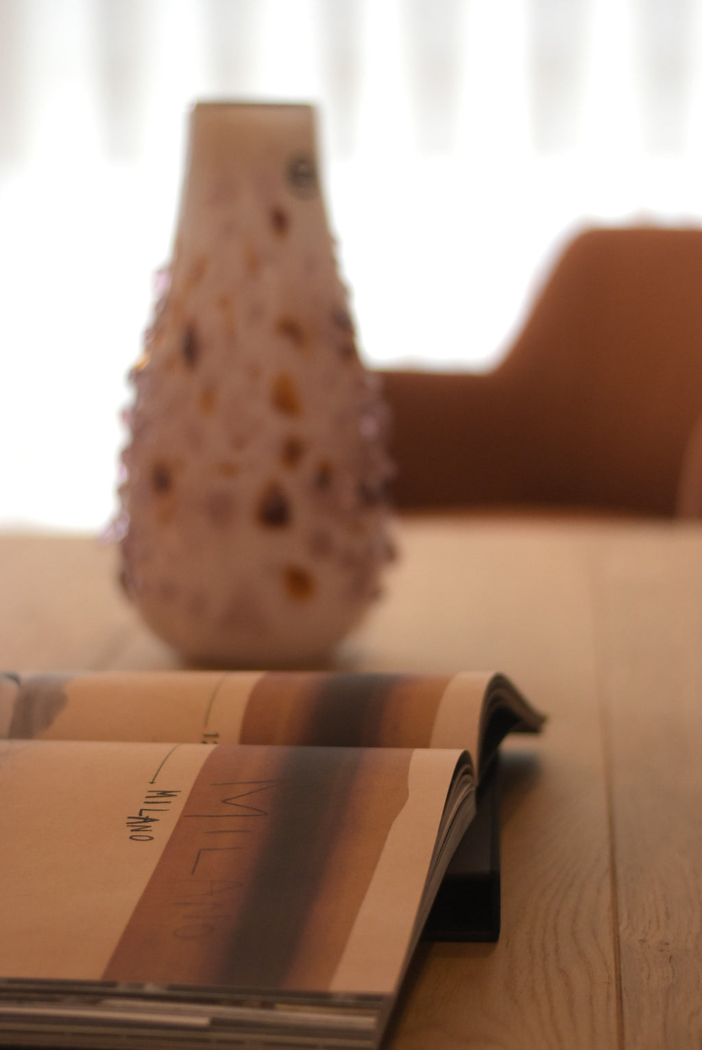 Spotted vase by Object and Story with an opaque finish and spiked texture, set on a wooden surface.