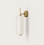 Modern brass wall sconce with ribbed glass shade, minimalist lighting for contemporary interiors