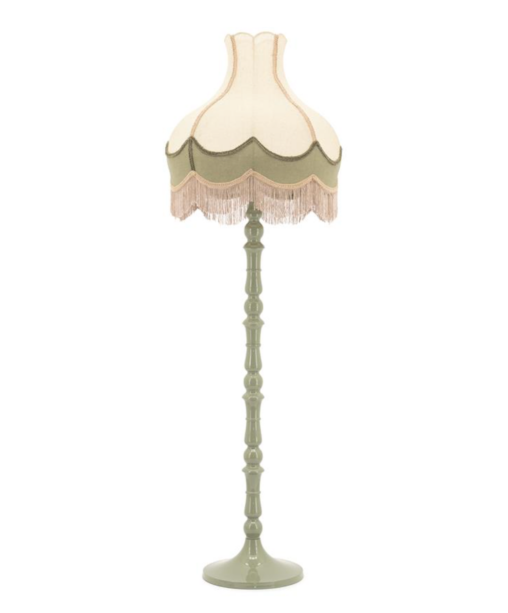Sage green floor lamp with a two-tone, scalloped shade and long beige fringe, on a decorative turned base.