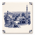White ceramic tile with a blue and white illustration of Park Güell, Barcelona skyline, and corner motifs.