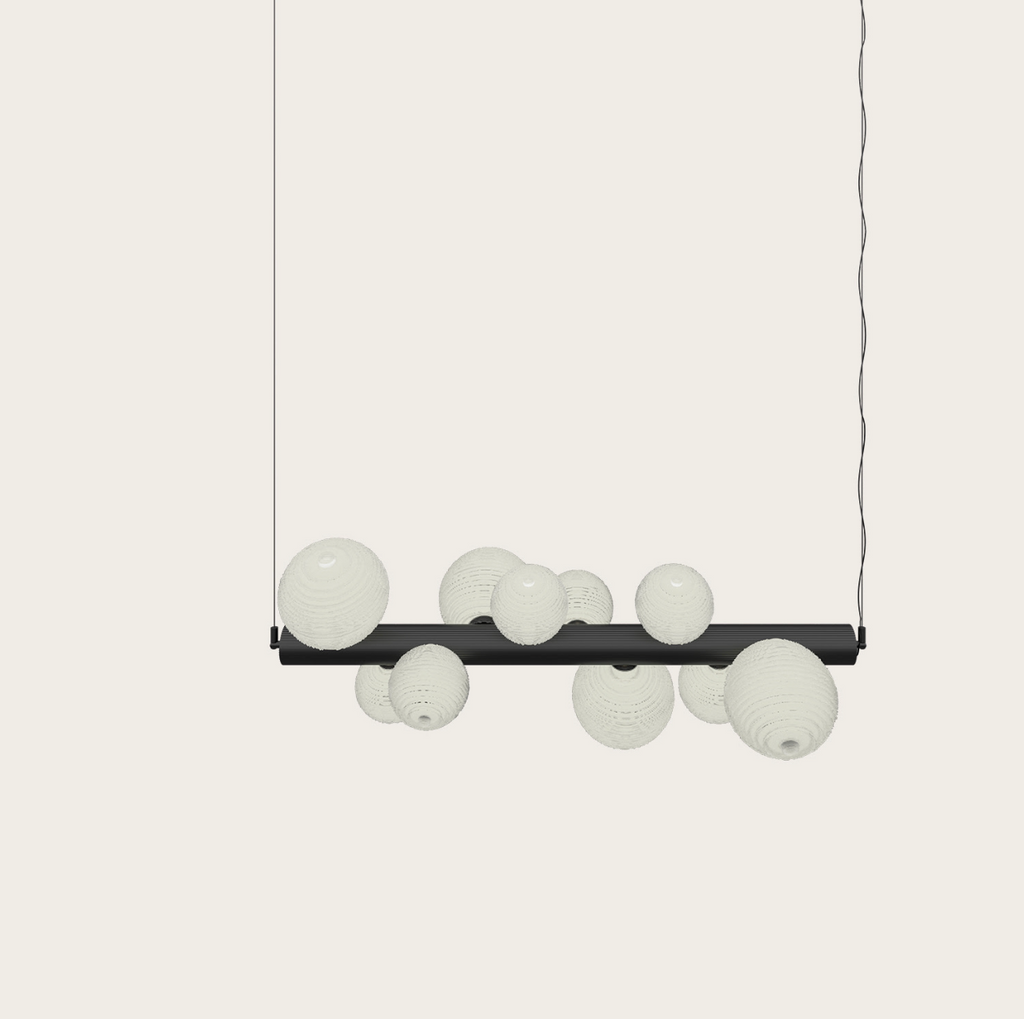 Modern pendant light with black bar and textured white globe shades, ideal for contemporary interiors.