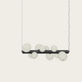 Modern pendant light with black bar and textured white globe shades, ideal for contemporary interiors.