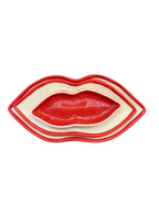 Set of three nested red and cream lip-shaped dishes with a glossy finish.