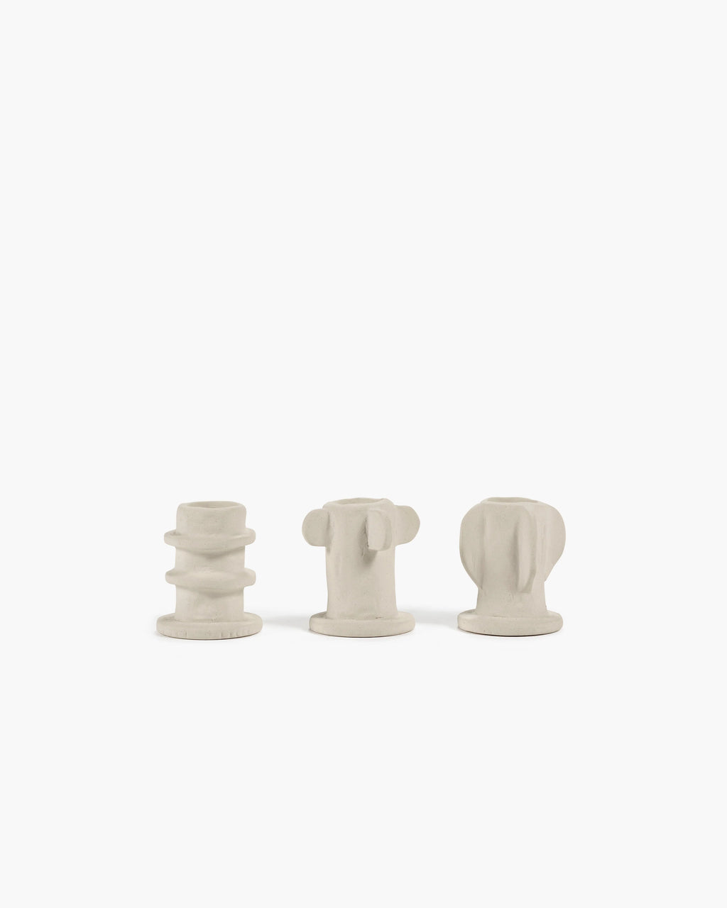 Light grey Molly candle holder set featuring three textured, sculptural designs on a white background.