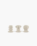 Light grey Molly candle holder set featuring three textured, sculptural designs on a white background.