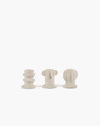 Light grey Molly candle holder set featuring three textured, sculptural designs on a white background.
