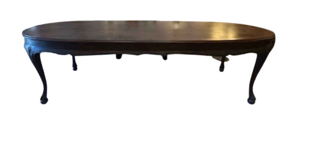 Dark brown polished wood oval table with carved apron and cabriole legs.
