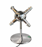 Polished chrome table lamp with a spherical body, central lens, and four radiating arms on a round metal base.
