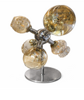 Chrome table lamp with amber and textured clear glass globe shades, featuring a molecular design on a round base.