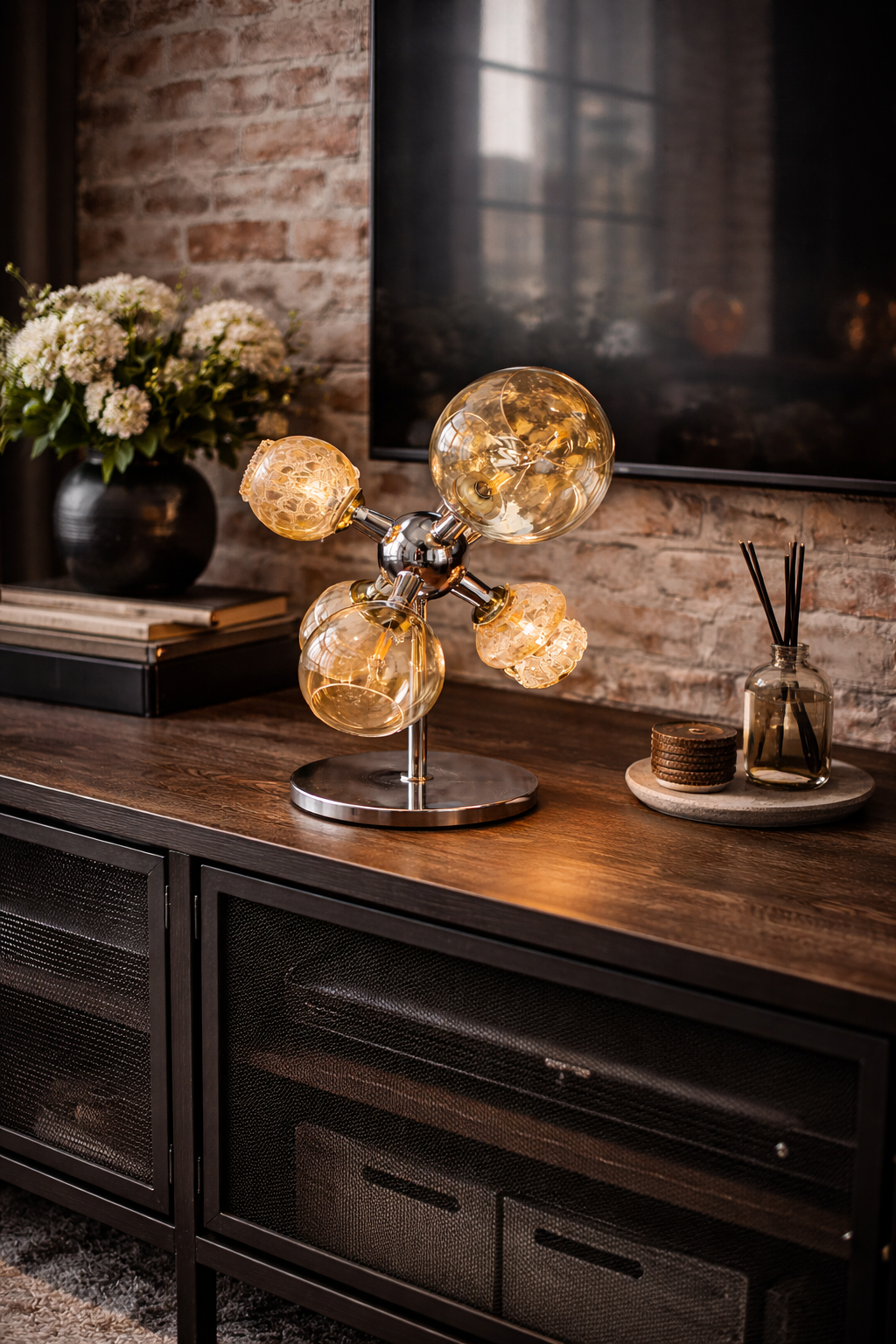 Orion Table Lamp with amber spherical bulbs and a chrome base, styled on a dark wood console.