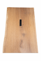 Light brown wood table with natural live edges, visible grain, and an embedded black control panel.
