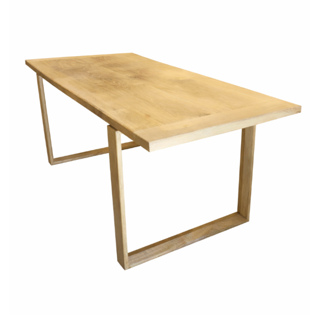 Modern rectangular light wood table with unique U-shaped frame legs, angled view.