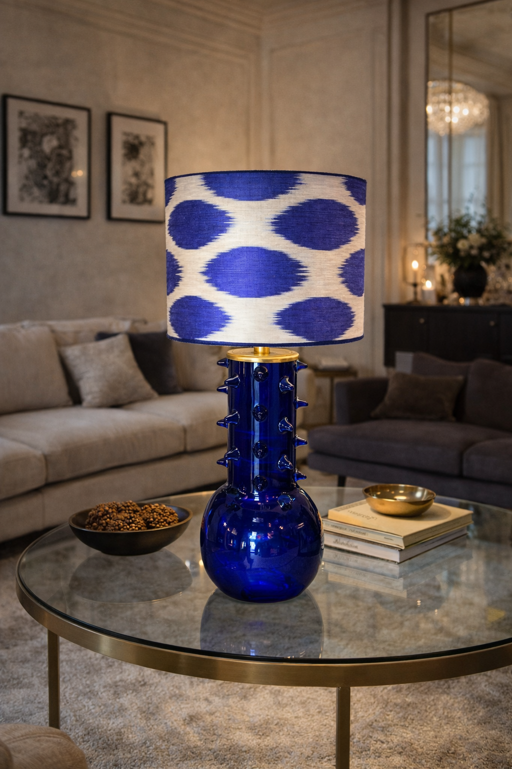 Provet Lamp with a cobalt blue spiked glass base and white and blue ikat patterned shade on a coffee table.