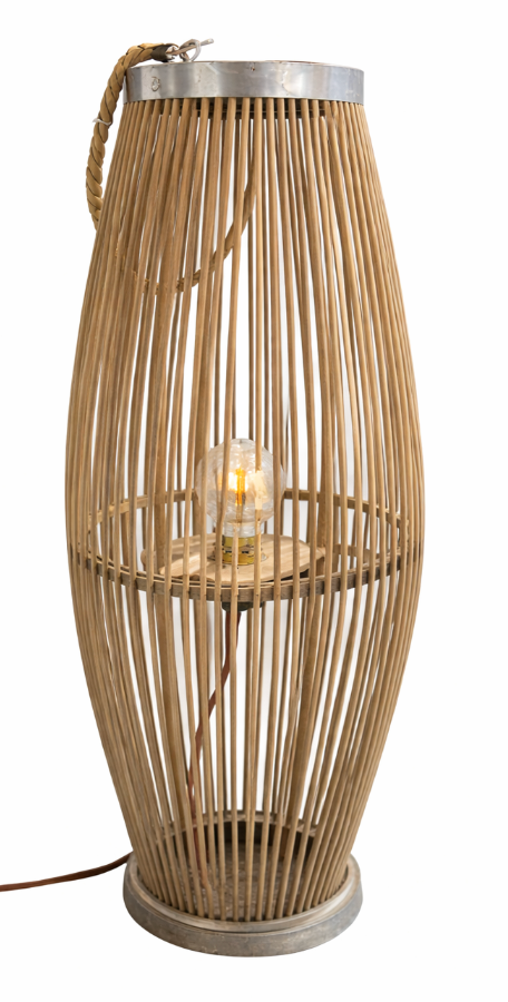 Rafia floor lamp made of vertical natural wood sticks, with a metal top, rope handle, and an exposed glowing bulb.