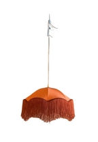 Terra cotta fabric hanging lamp with a scalloped shade and long tassel fringe.