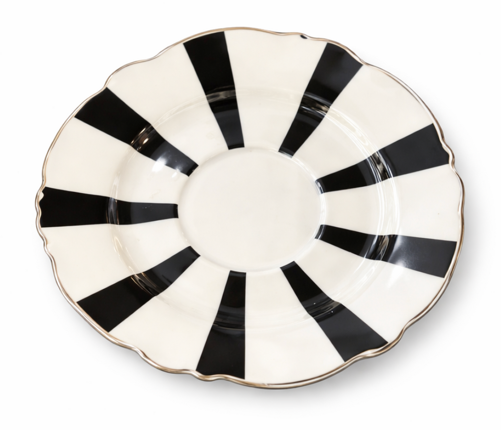 Round black and white striped saucer with a scalloped edge and gold rim.