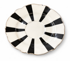 Round black and white striped saucer with a scalloped edge and gold rim.