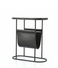 Black metal side table with an oval dark marble top and a black leather magazine holder featuring decorative stitching.