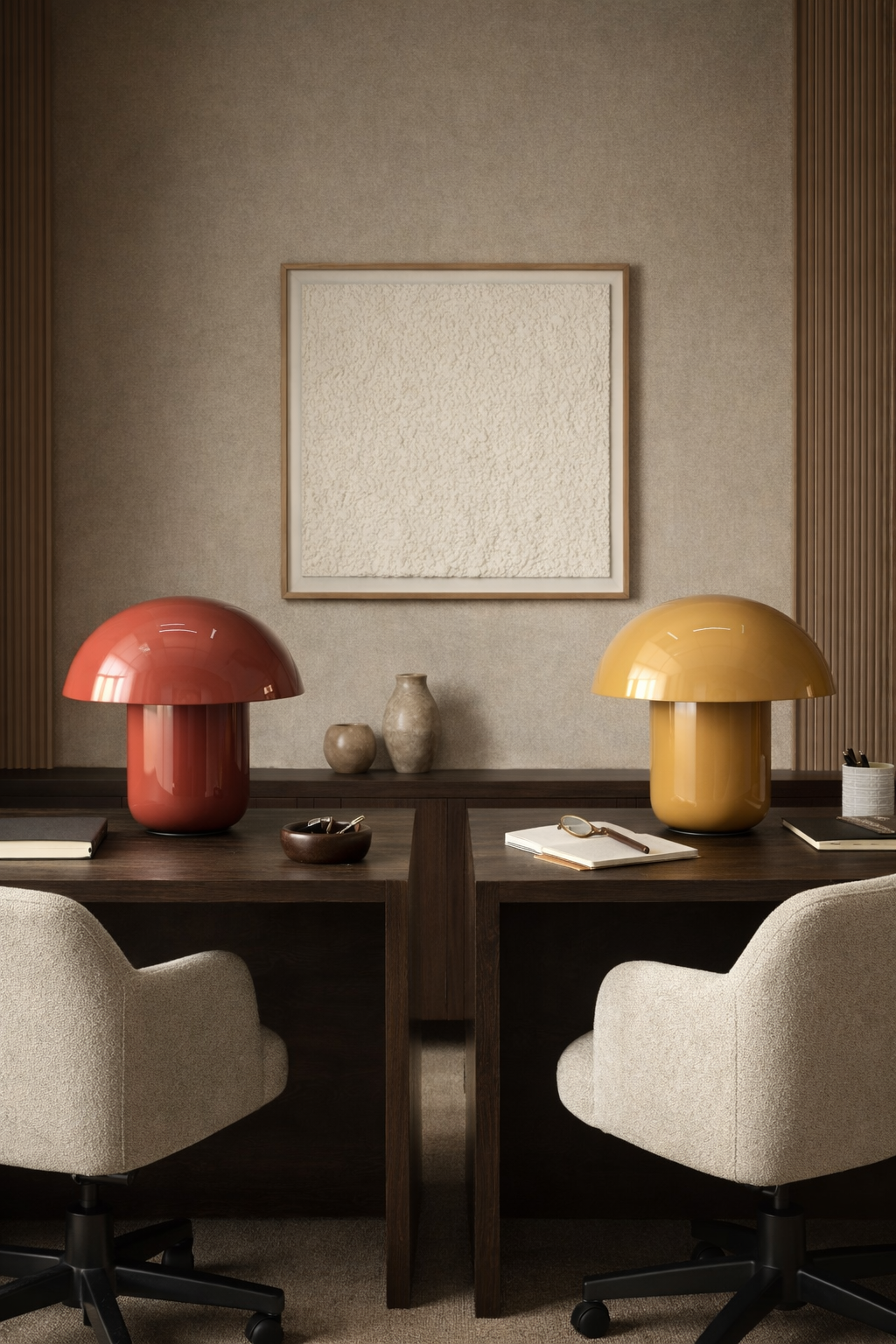 Two glossy, red and yellow, mushroom-shaped desk lamps on dark wood desks in a modern office.