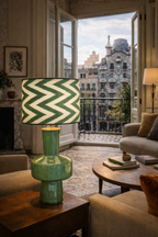 Ziggy table lamp with green ceramic base and a green and white zigzag patterned shade in a living room.