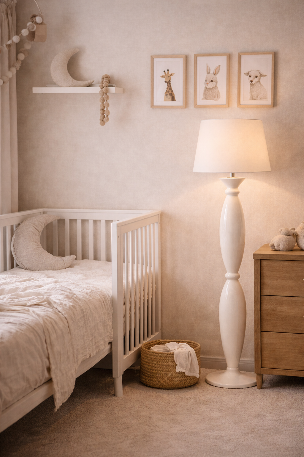 White Alfil floor lamp with a conical shade and elegant sculpted base, in a cozy nursery.