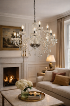 Crystal Chandelier Lamp with multiple candle-style bulbs and draped crystal drops, illuminating an elegant living room.