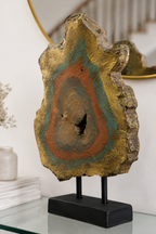 Hand-painted wood slice sculpture with gold, teal, and rust hues on black stand for modern home decor