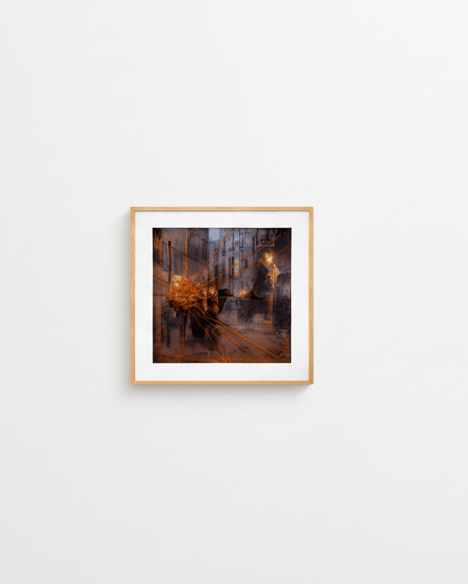 Framed abstract painting by Manuel Cohen, a dark street scene with radiating orange lines in warm tones, on a white wall.