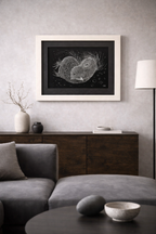 Mirlo Artwork in a light frame, featuring intricate white abstract patterns on a black background.