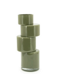 Moss green Pila vase with four stacked, modular sections, some faceted, and a clear glass base.