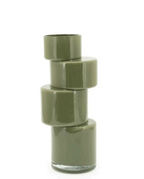 Moss green Pila vase with four stacked, modular sections, some faceted, and a clear glass base.