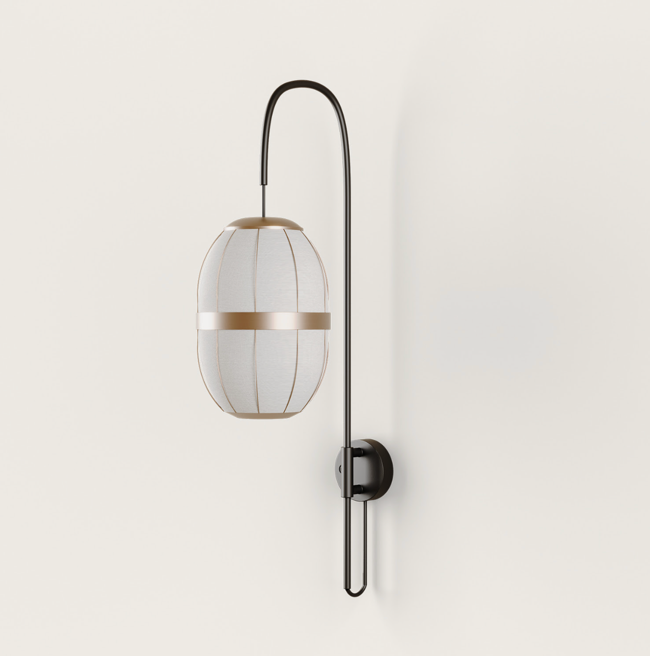 Dark metal wall lamp with an elongated light fabric shade and golden accent band, mounted on a cream wall.