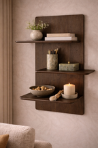Dark brown wooden wall-mounted display shelf with three rounded shelves styled with home decor.