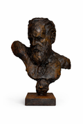 Dark bronze textured bust sculpture of a bearded man with an intense expression, on a rustic square base.