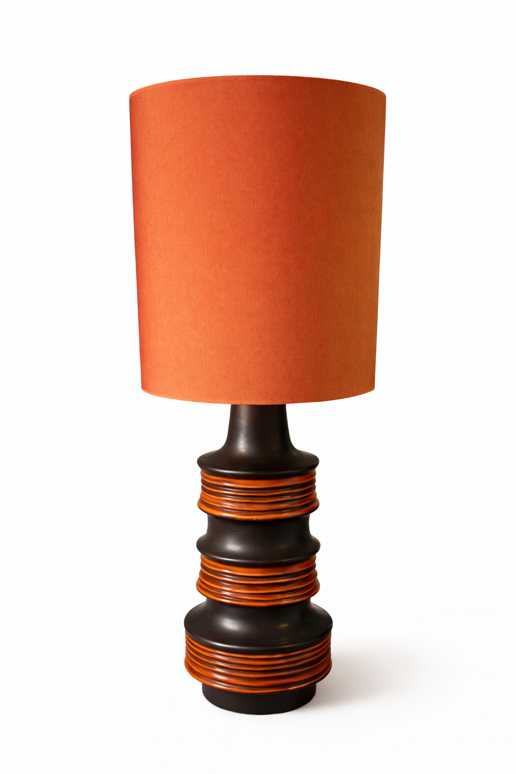 Orange fabric shade table lamp with a dark brown ceramic base featuring ribbed orange rings.